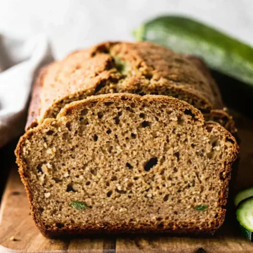 Slices of moist homemade zucchini bread on a decorative plate