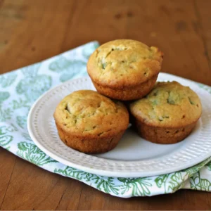 Banana zucchini muffins on white plates