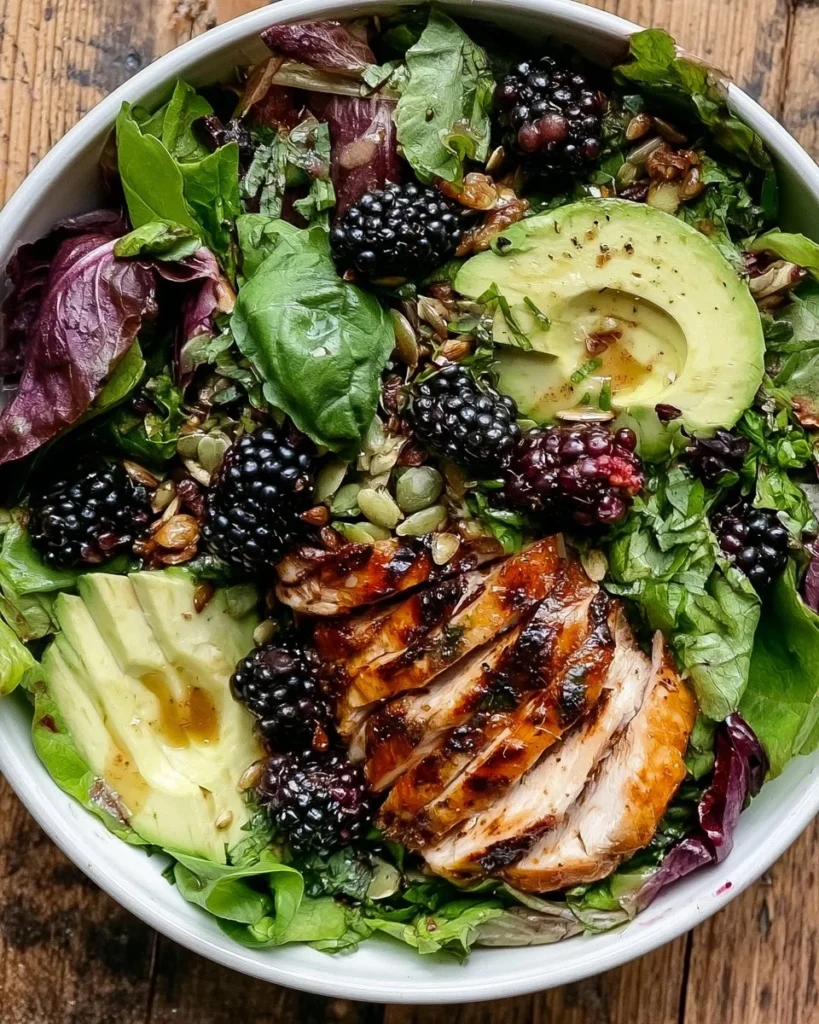Delicious blackberry basil salad topped with grilled chicken for a healthy meal.